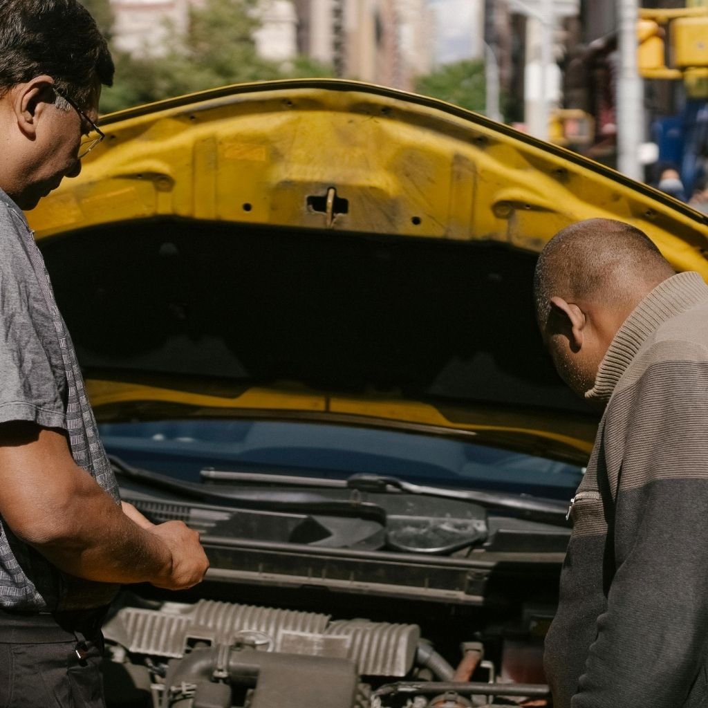 Two people negotiating the price of a broken car.