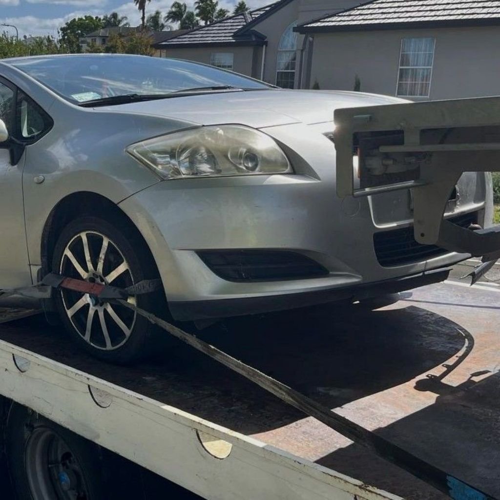 A tow truck transporting a broken car.